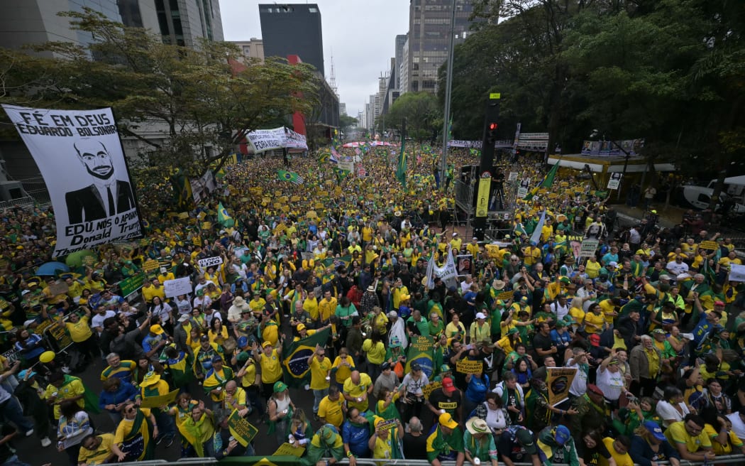 Supporters of Brazil's former president (2019-2022) Jair Bolsonaro, on trial for his alleged role in an attempted coup, take part in a demonstration during Independence Day, in Sao Paulo, Brazil on September 7, 2025. Bolsonaro will test his political strength with demonstrations in the country's main cities, days before the Supreme Court deliver its verdict. The far-right leader, also a former army captain, risks up to 43 years in prison if convicted of attempting to cling to power after losing 2022 elections to his leftist rival Luiz Inacio Lula da Silva. (Photo by NELSON ALMEIDA / AFP)