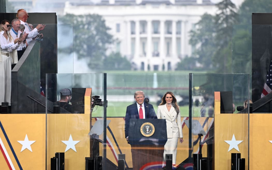 US President Donald Trump and US First Lady Melania Trump take the stage during the Army 250th Anniversary Parade in Washington, DC.