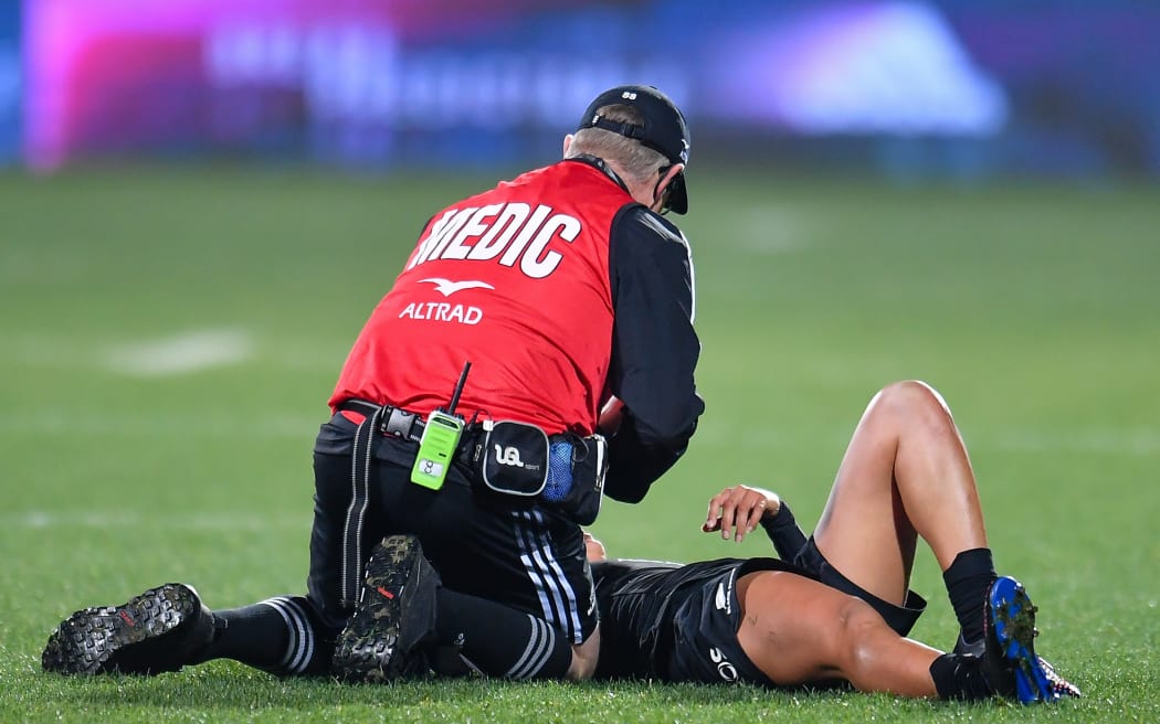 Tyla Nathan-Wong of the Black Ferns receives treatment from a medic.
