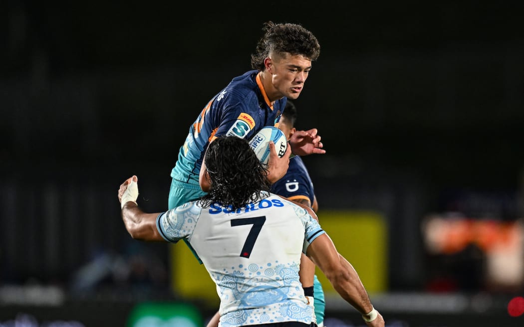 Kyren Tamouefolau tackled by Charlie Gamble of the Waratahs.
