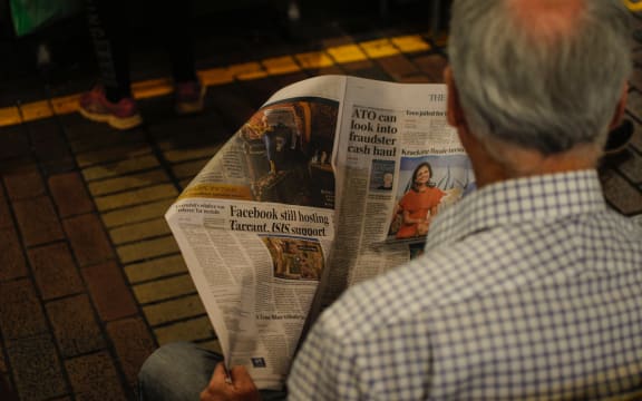 man reading newspaper
