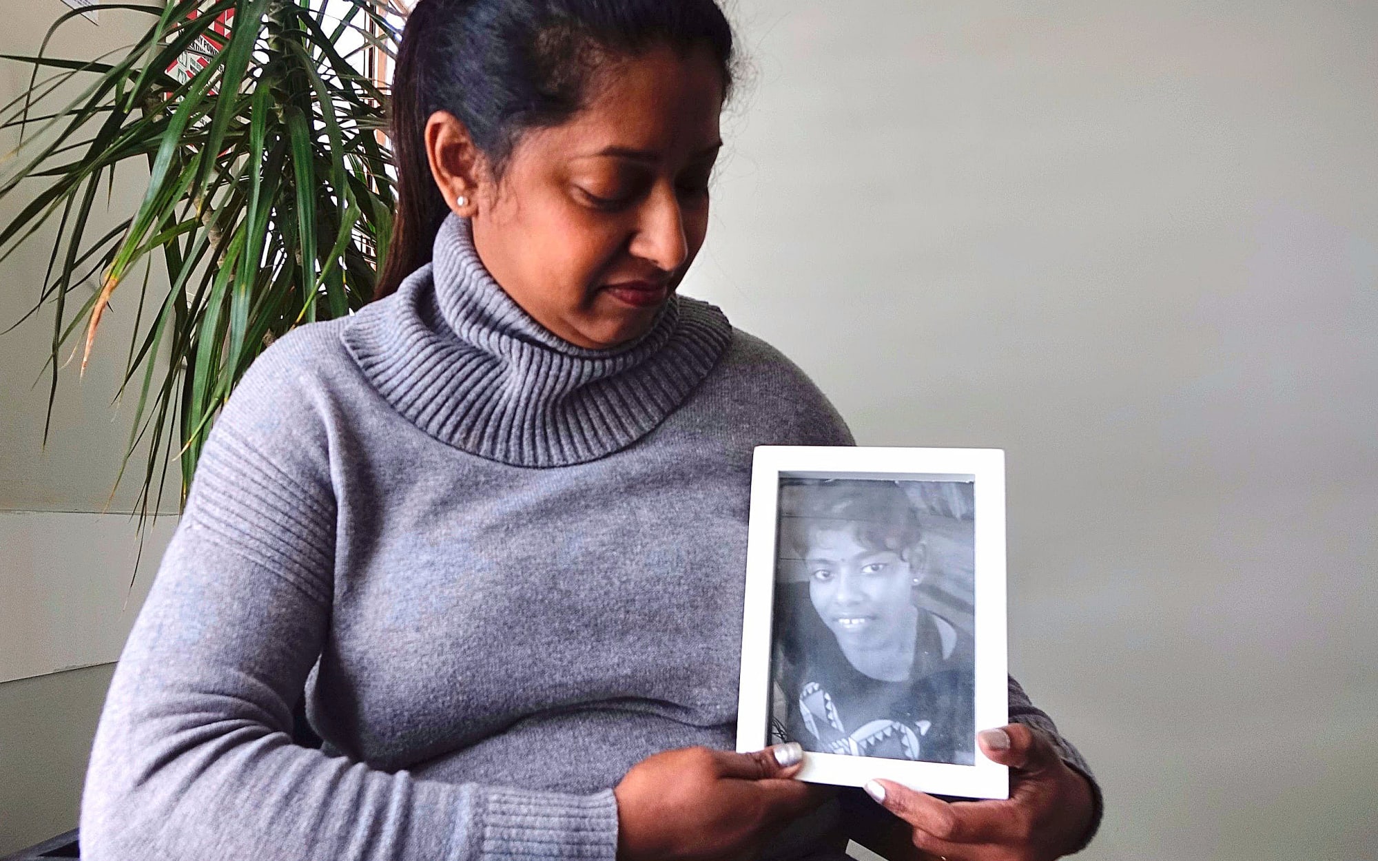 Sangeeta Bali holds a photograph of her daughter Shurti, 13, who lives in Fiji and has been denied a visa to come to New Zealand