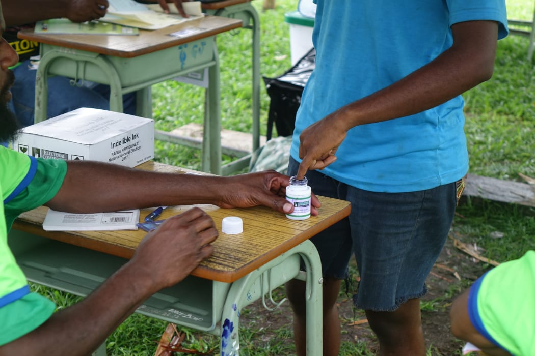 PNG voters must dip a finger into indelible ink before voting, an effort to ensure they don't vote twice.
