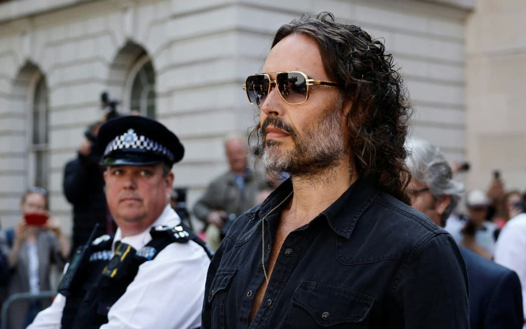 British actor and comedian Russell Brand departs Westminster Magistrates Court in London on May 2, 2025. British comedian and actor Russell Brand was on Friday bailed by a London court after he appeared to face five charges of rape and other sexual offences. (Photo by BENJAMIN CREMEL / AFP)