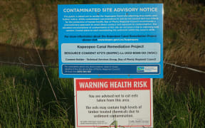 Sign warning of health risk due to chemicals and advising against  collecting eels etc