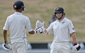Black Caps Jeet Raval and Tom Latham celebrate their 100 run opening partnership on Day 2 of the first cricket Test against Bangladesh.