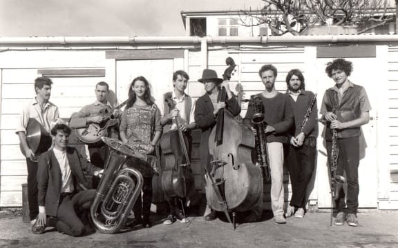The nine members of the Braille Collective circa 1985 with instruments