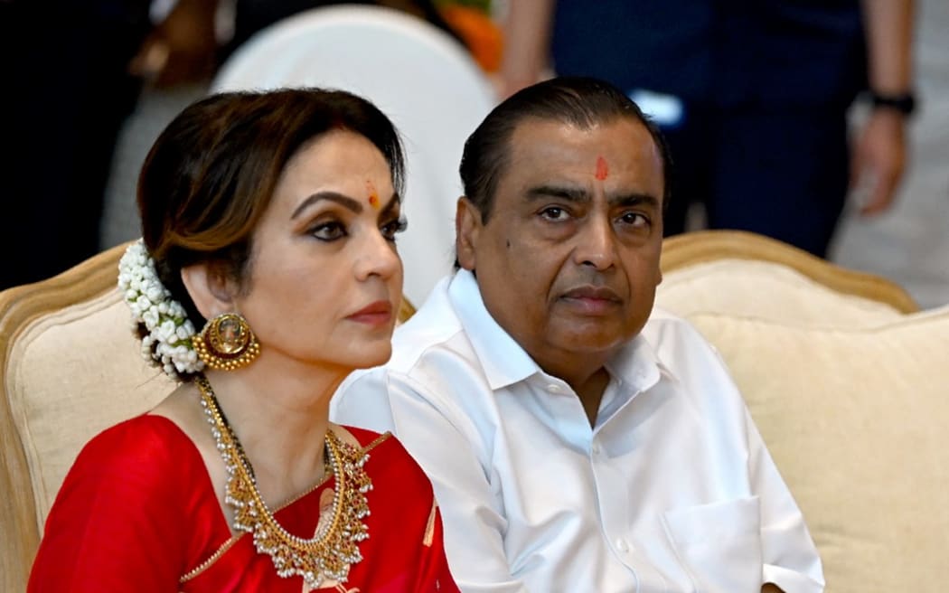 Billionaire tycoon and Chairman of Reliance Industries Mukesh Ambani (R) with his wife Nita Ambani attends a mass wedding ceremony of underprivileged couples ahead of their son Anant Ambani's wedding to Radhika Merchant.