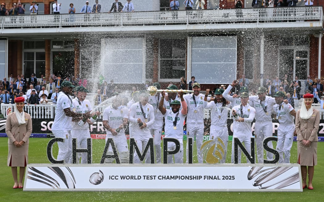 South Africa's captain Temba Bavuma holds up the ICC World Test Championship Mace as he celebrates with teammates after victory on day four of the ICC World Test Championship cricket final match between Australia and South Africa, at Lord's cricket ground, in London, on June 14, 2025. South Africa won the Test by 5 wickets. (Photo by Glyn KIRK / AFP) / RESTRICTED TO EDITORIAL USE. NO ASSOCIATION WITH DIRECT COMPETITOR OF SPONSOR, PARTNER, OR SUPPLIER OF THE ECB