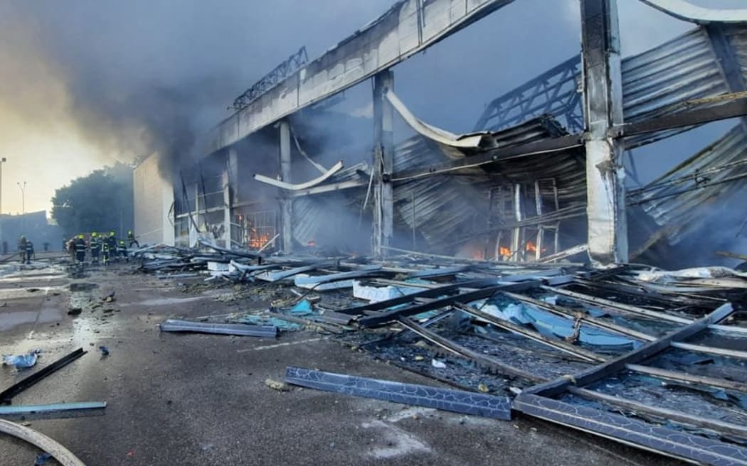 Firefighters put out a blaze in a mall hit by a Russian missile strike in the eastern Ukrainian city of Kremenchuk, in a picture taken and released by the Ukraine's State Emergency Service on 27 June, 2022.