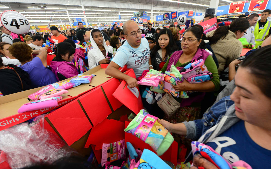 People get an early start on Black Friday shopping deals at a Walmart Superstore on November 22, 2012 in Rosemead, California, as many retailers stayed opened during the Thanksgiving celebrations, evidence that even this cherished American family holiday is falling prey to the forces of commerce. AFP PHOTO / Frederic J. BROWN (Photo by FREDERIC J. BROWN / AFP)