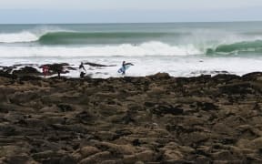 Surfers at Whale Bay near Raglan.
