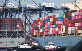 Shipping containers are stacked on container ships at the Port of Los Angeles on 25 June, 2025, in Los Angeles, California.