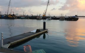 The Auckland waterfront on Tuesday morning after a wind blast being described as a tornado sent a ferry adrift, and blew shipping containers into the sea.
