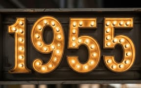 The number nineteen fifty five spelt out in lightbulbs like an old Broadway sign