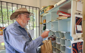 PO volunteer Peter Sander sorting some mail