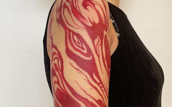 Red ink tattoo which took tattoo artist Rose Hu 10 hours to create