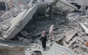 Palestinians check the rubble of their houses destroyed during the Israeli military operations against Hamas in Khan Yunis, Gaza, on May 11, 2024. Thousands of homes of people in the densely populated Gaza Strip have been turned into rubble with heavy clashes, and more than 10,000 people are estimated to be missing under rubble in Gaza, according to the Palestinian Civil Defense. (Photo by Saeed Jaras / Middle East Images / Middle East Images via AFP)