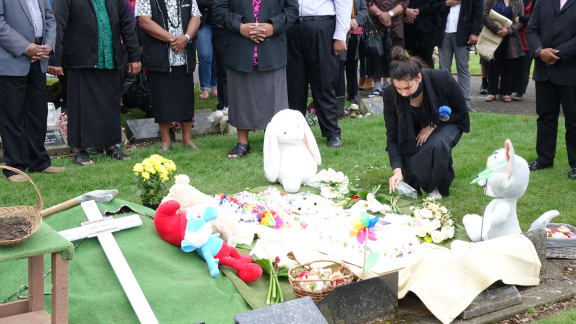 Flowers are placed on Mona's grave