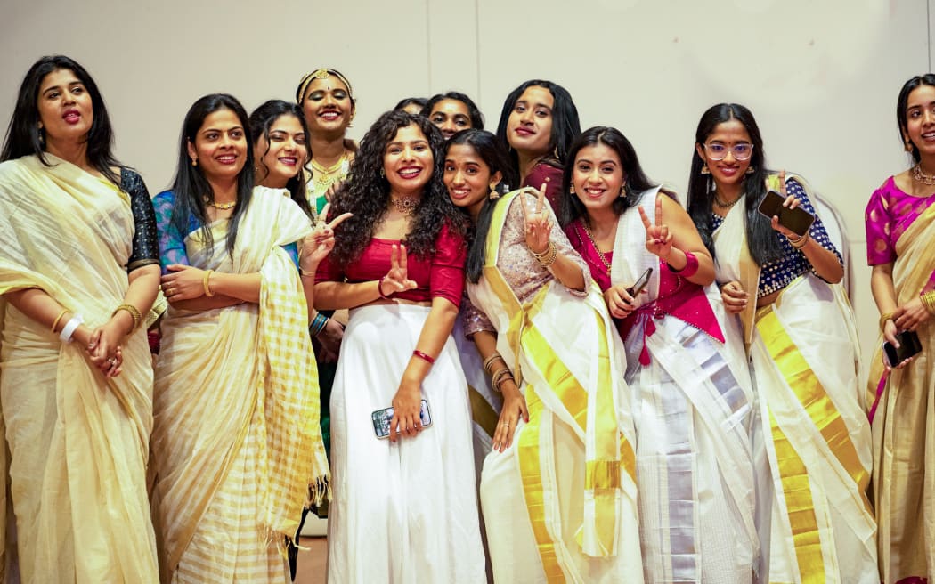 A group of young women in traditional attire at the Wellington Onam celebration.