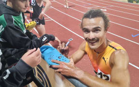 Sam Tanner celebrates with fans after winning the NZ championship mile at the Cooks Classic.