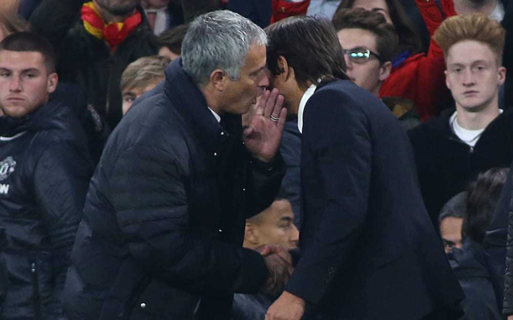 Manchester United manager Jose Mourinho, left, shakes hands with Chelsea counterpart Antonio Conte.