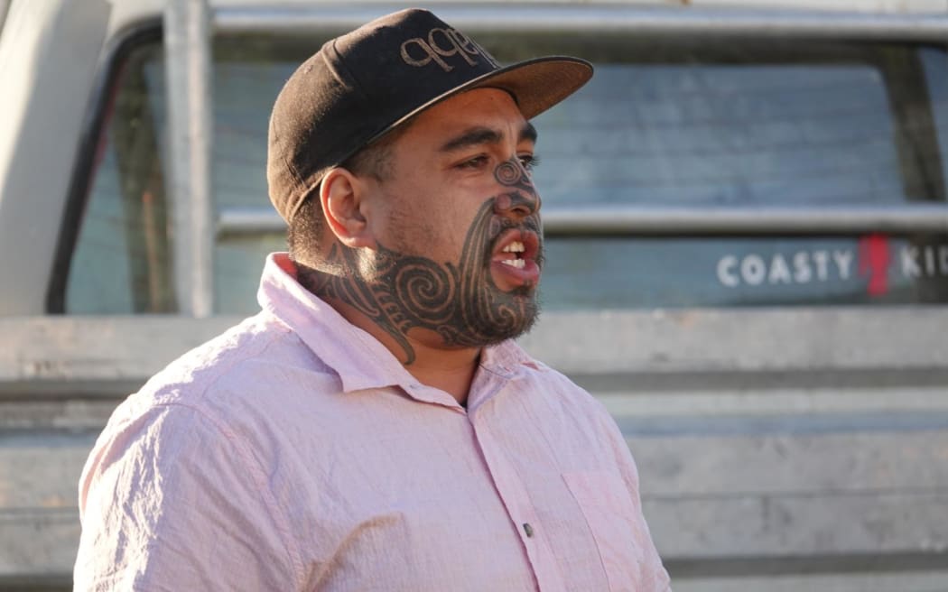 Artist Tamatamarangi Clausen wears a black cap and lilac coloured shirt.