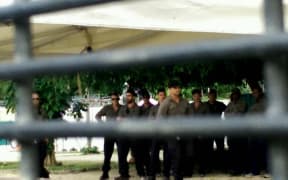 Officials gathered at the gate of Foxtrot compound.