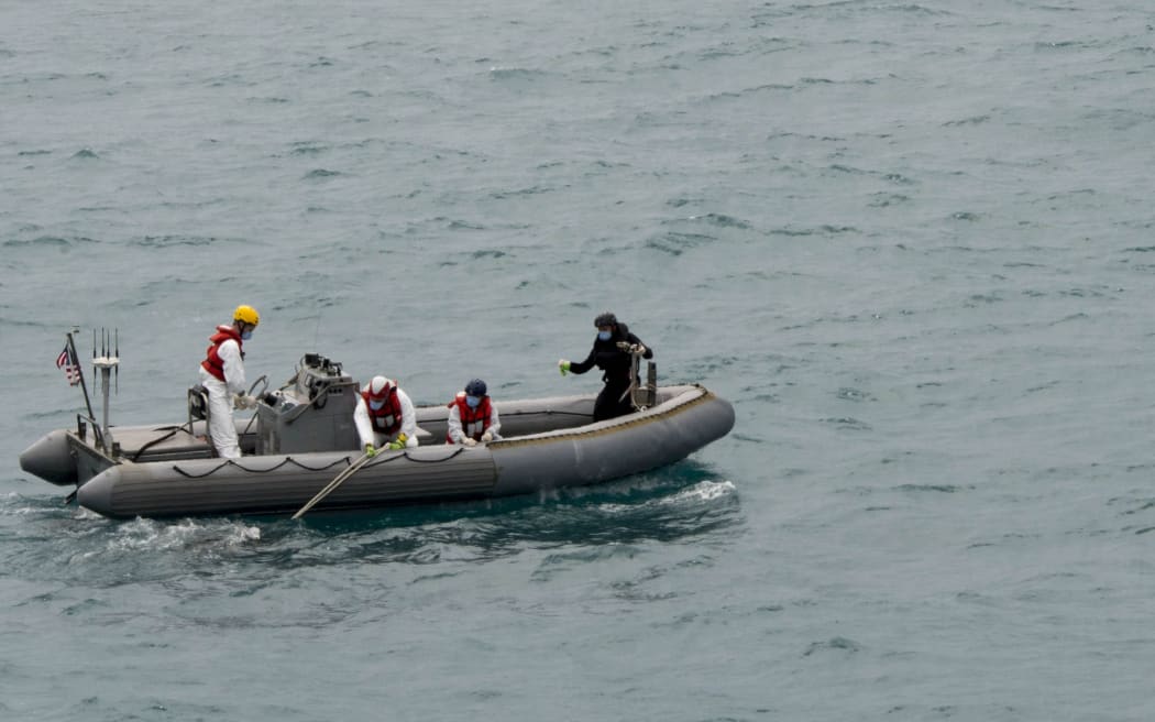 Previous attempts by divers have failed because of zero visibility on the sea floor and bad weather.

AFP PHOTO HANDOUT-US NAVY/Mass Communication Specialist 1st Class Brett Cote"/