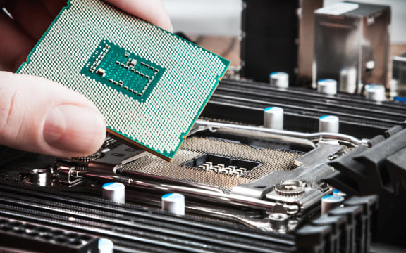 CPU in hand before installation into the motherboard