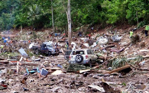 This photo taken on 30 September, 2009 shows rescuers working through the rubble from the devastation caused when the tsunami hit the south coast of Samoa.
