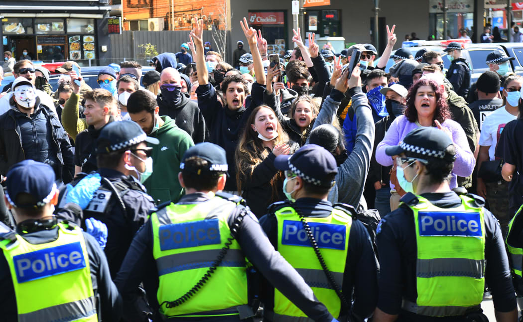 Anti-lockdown protesters chant slogans at Melbourne's Queen Victoria Market during a rally on 13 September