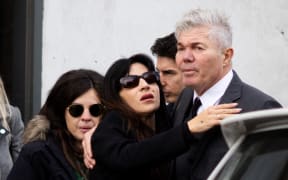 Dalma (L) and Gianinna Maradona, daughters of late Argentine football legend Diego Maradona, say goodbye to their lawyer Fernando Burlando after a trial hearing in San Isidro, outskirts of Buenos Aires on May 29, 2025. An Argentine court on Thursday nullified the trial of late football legend Diego Maradona's medical team and ordered a new one, after a judge stepped down over her role in a documentary about the case. (Photo by TOMAS CUESTA / AFP)