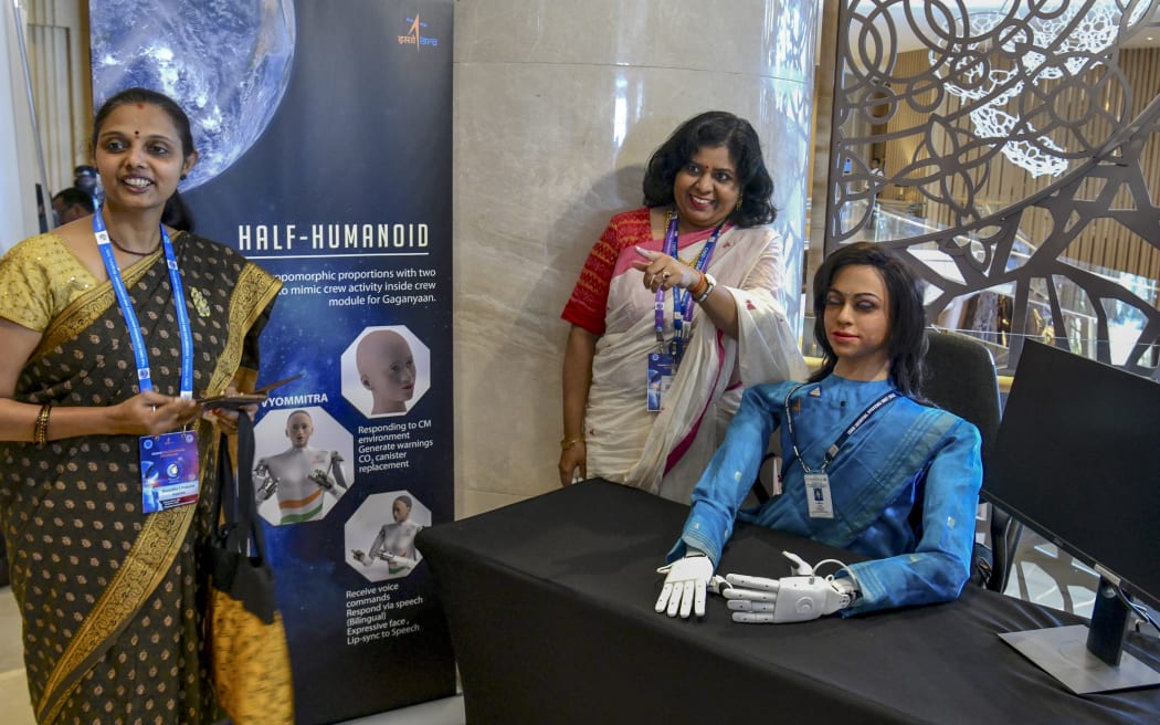 Visitors look at 'Vyommitra', the first prototype half-humanoid robot developed by Indian Space Research Organisation for its planned 'Gaganyaan' unmanned mission, at an exhibition during a symposium on Human Spaceflight and Exploration - Present Challenges and Future Trends in Bangalore on January 23, 2020.