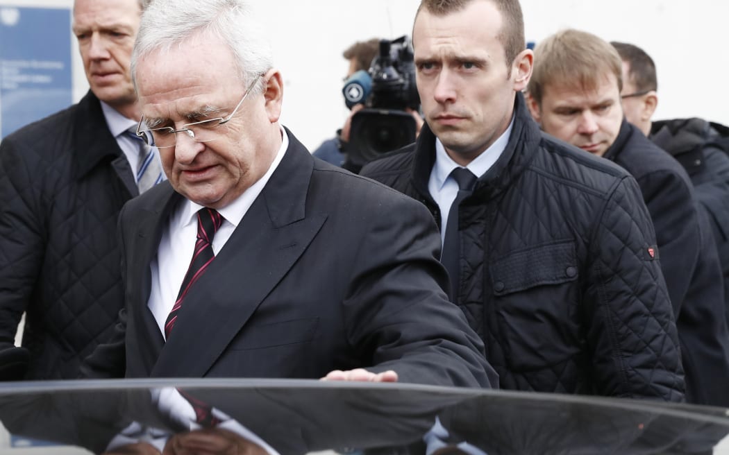 Former Volkswagen boss Martin Winterkorn gets (L) into his car as he leaves the Bundestag (Lower house of parliament) compound, on January 19, 2017 in Berlin, where he faced a parliamentary committee investigating the "dieselgate" scandal.