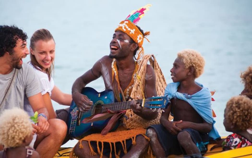 Tourists are entertained in Papua New Guinea.