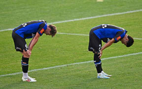 Auckland FC’s Nando Pijnaker (L) and Hiroki Sakai dejected following their A-League loss to Western United.