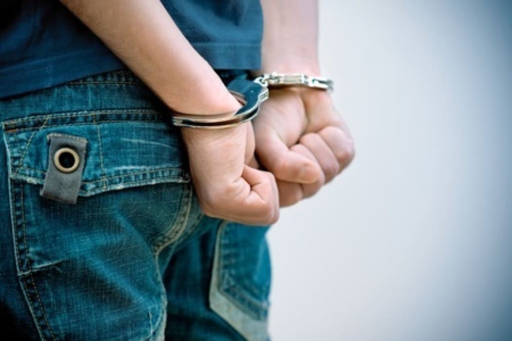 Youth in handcuffs