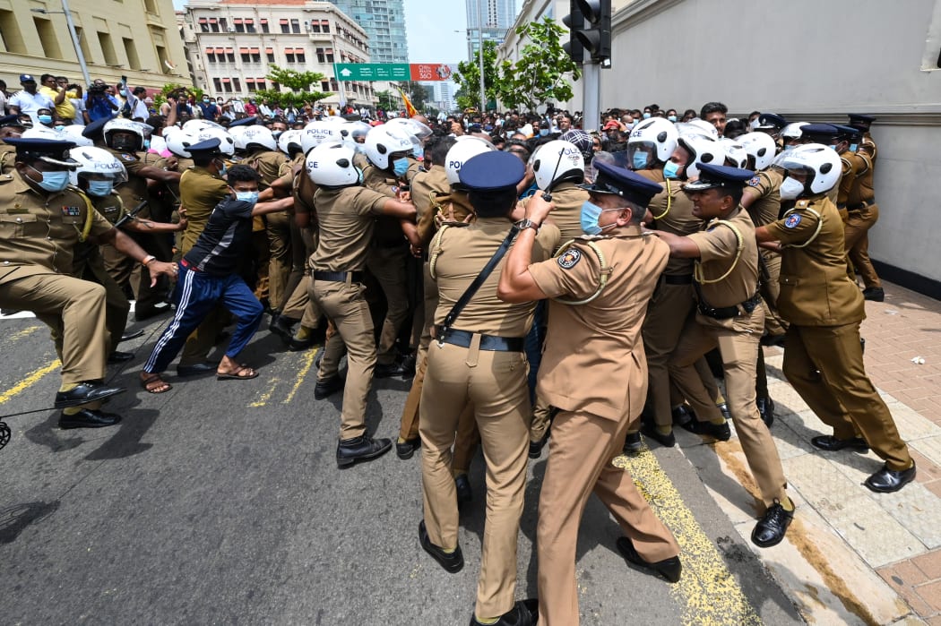 Government supporters and police clash outside the president's office in Colombo on 9 May 2022.
