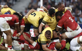 Tonga's tighthead prop Ben Tameifuna (#03) challenges Romanian players in a ruck during the France 2023 Rugby World Cup Pool B match between Tonga and Romania at the Stade Pierre-Mauroy in Villeneuve-d'Ascq, near Lille, northern France on October 8, 2023. (Photo by Sameer Al-Doumy / AFP)