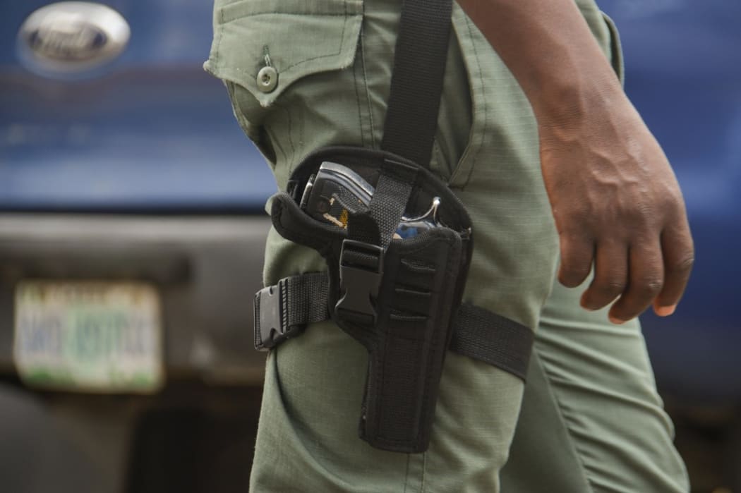 police officer on duty with Glock service revolver patrols during Stakeholders Engagement on Internal Security and Conflict Resolution across the country held in Lagos State