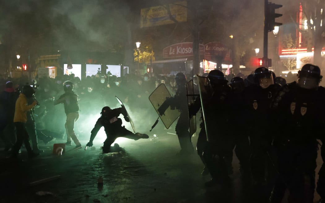French riot police in Paris clash with protesters during a demonstration against the 'global security' draft law on 28 November.