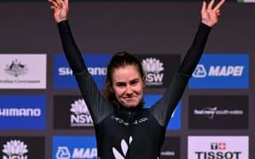 Niamh Fisher-Black of New Zealand celebrates on the podium after winning the U23 women's road race cycling event at the UCI 2022 Road World Championship in Wollongong.