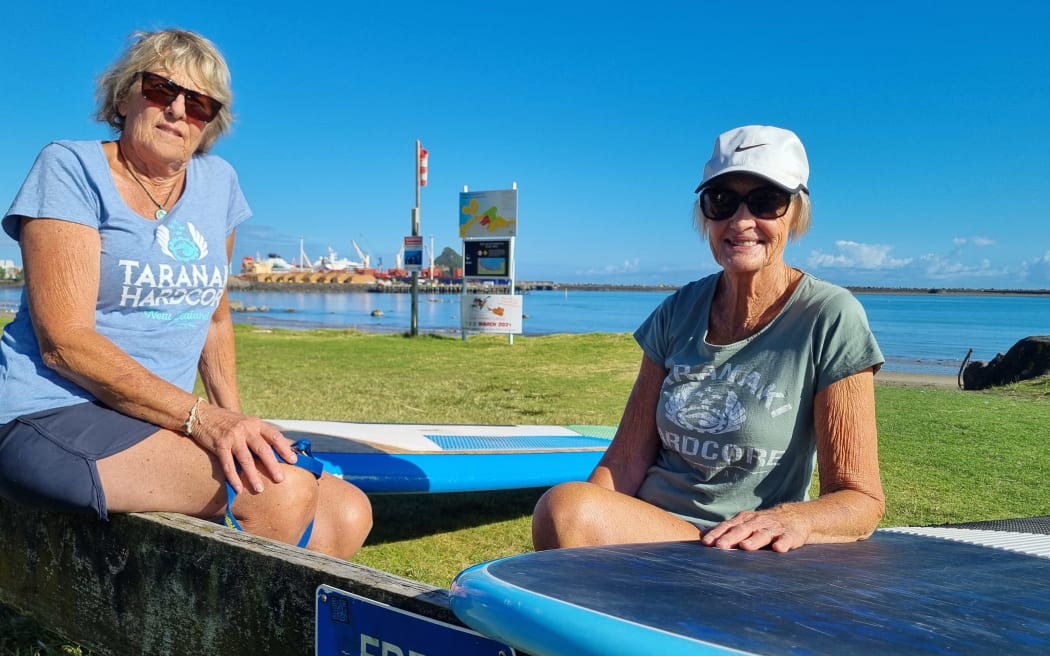 Trish Dwyer and her mate Raewyn (right) took stand-up paddle boards out in the harbour to greet the Seabourn Sojourn at Port Taranaki.