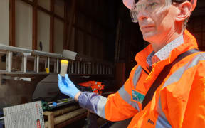 Steve Hutchison from Wellington Water holding some sludge.