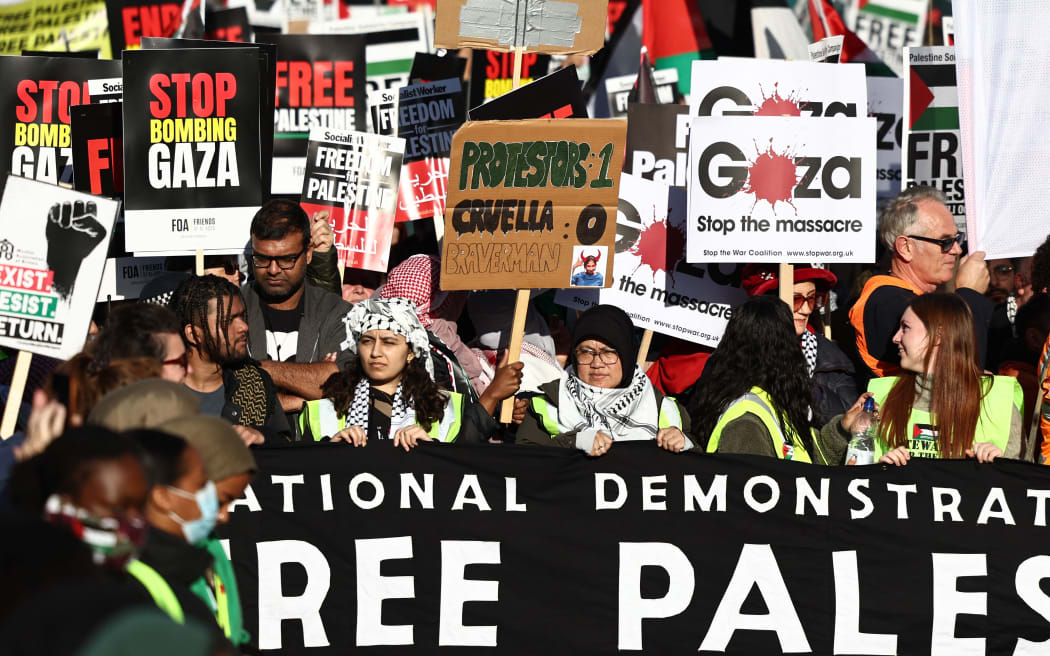Protesters gather with placards and flags for the 'National March For Palestine' in central London on November 11, 2023, calling for a ceasefire in the conflict between Israel and Hamas.
