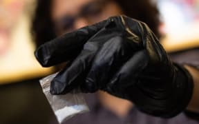 An NGO carrying out testing on drugs at an event - including this bag of cocaine, in Colombia, in 2021.