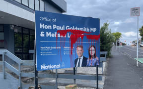 Red paint splattered over a sign outside the electorate office of National Party MPs Melissa Lee and Paul Goldsmith in November 2023.