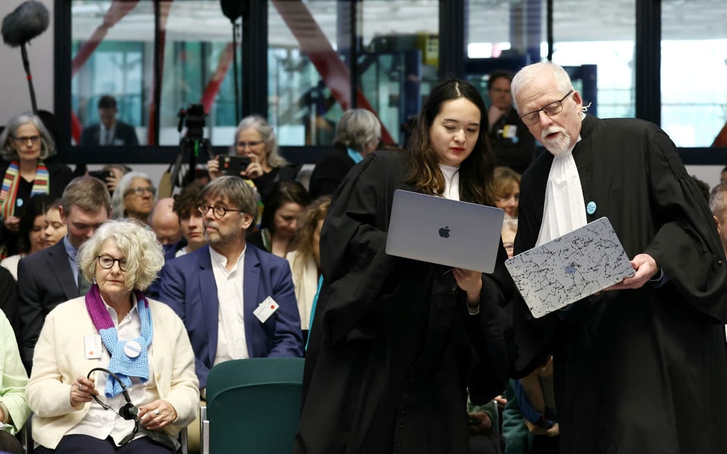 Representatives and lawyers of three climate change cases involving France, Portugal and Switzerland attend a hearing of the European Court of Human Rights (ECHR) to decide in three separate cases if states are doing enough in the face of global warming in rulings that could force them to do more, in Strasbourg, eastern France, on April 9, 2024. All three cases accuse European governments of inaction or insufficient action in their measures against global warming. In a sign of the importance of the issue, the cases have all been treated as priority by the Grand Chamber of the ECHR, whose 17 judges can set a potentially crucial legal precedent. (Photo by Frederick FLORIN / AFP)