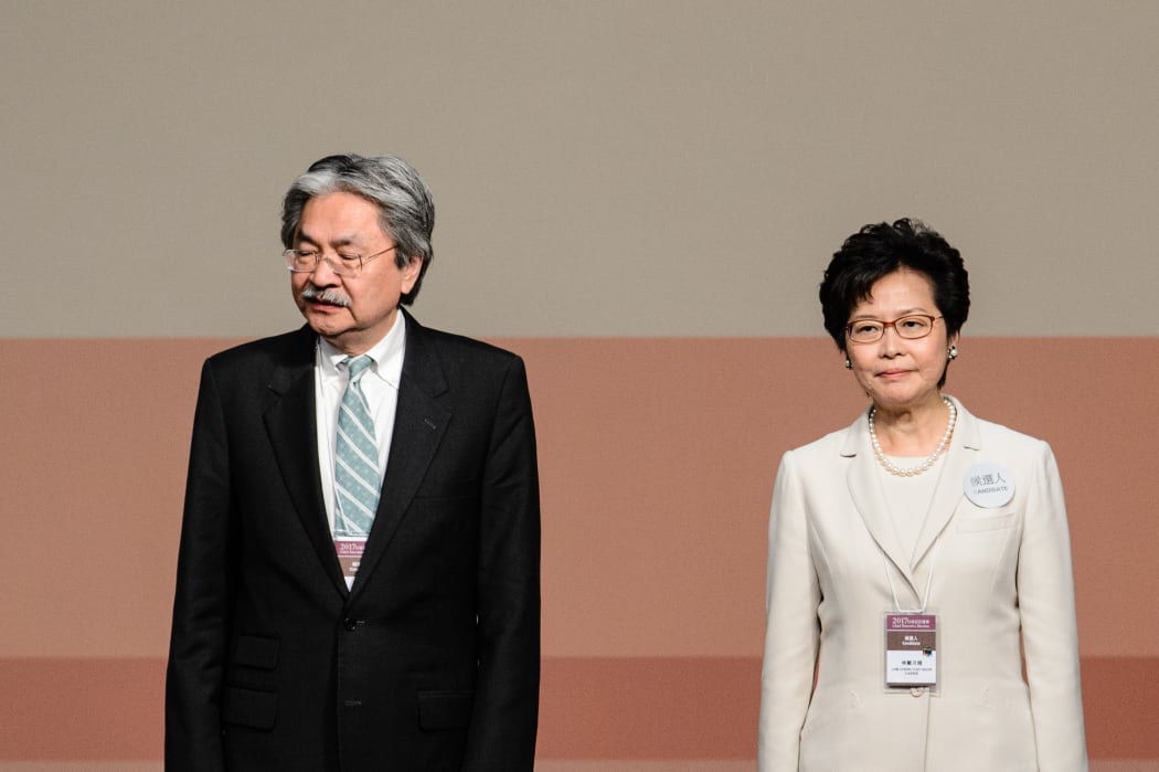 Carrie Lam and her defeated opponent John Tsang.